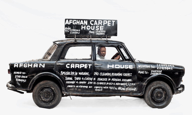Abdul's vehicle promotes his work as a carpet repair man in Mumbai, India.