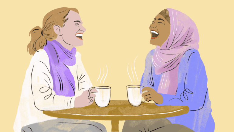 An illustration in a style mixing line drawing with pastel, shows two women laughing and talking over coffee at a cafe. The woman on the left has white skin, a sandy blonde ponytail, and wears a purple neck scarf and white sweater. The woman on the right has light brown skin, and wears a pink headscarf and a purple sweater. Both women hold white mugs with steam coming out of them and throw their heads back in laughter. They are set against a light yellow background.