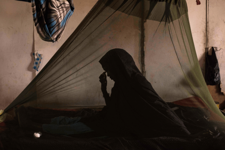 BARAWE, SOMALIA - A woman suffering from Tuberculosis sits in a bed at the Barawe General Hospital in Somalia.