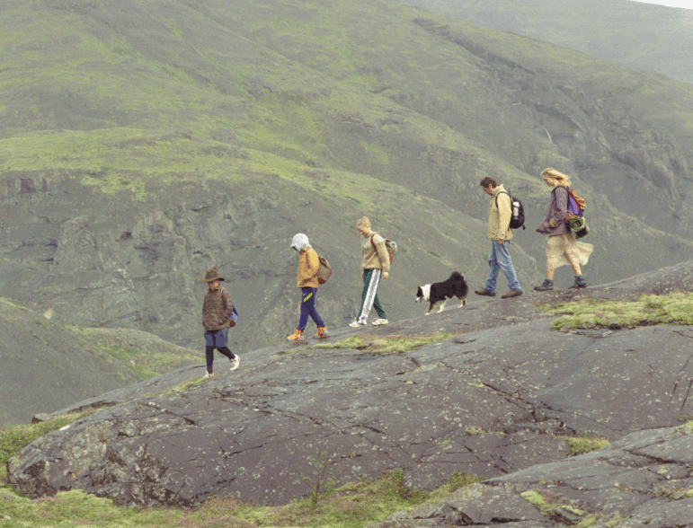 The family in The Love That Remains traversing a steep ridge in the hills in Iceland.