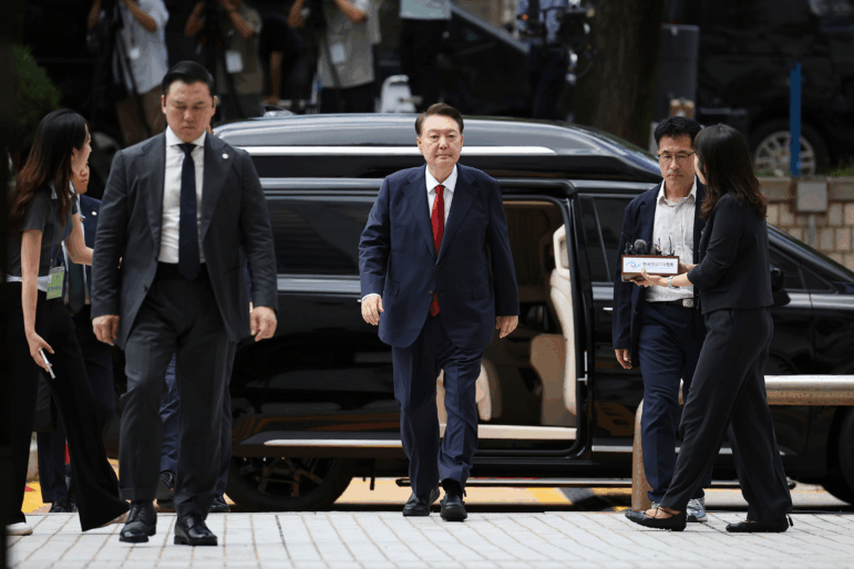 FILE - Former South Korean President Yoon Suk Yeol, center arrives at a court to attend a hearing to review his arrest warrant requested by special prosecutors in Seoul, South Korea, July 9, 2025.