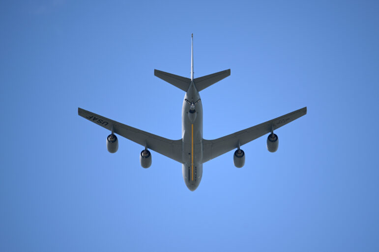 A U.S. Air Force KC-135 Stratotanker aerial refueling aircraft performs a flyover during the national anthem before an NCAA college football game.