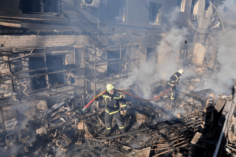 Firefighters put out the fire at a residential neighbourhood following a Russia missile and drone attack, in Brovary, close to Kyiv, Ukraine, on Saturday.