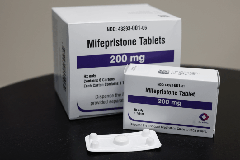 In this photo illustration, packages of Mifepristone tablets are displayed.
