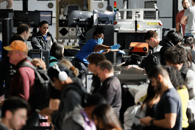 Passengers wait in line for a Transportation Security Administration checkpoint while traveling at Los Angeles International Airport November, 2025.