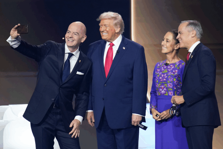 FIFA President Gianni Infantino (left) takes a selfie during the FIFA World Cup 2026 Official Draw with President Trump, Mexican President Claudia Sheinbaum, and Canadian Prime Minister Mark Carney at the John F. Kennedy Center for the Performing Arts in Washington, D.C., on Dec. 5, 2025.