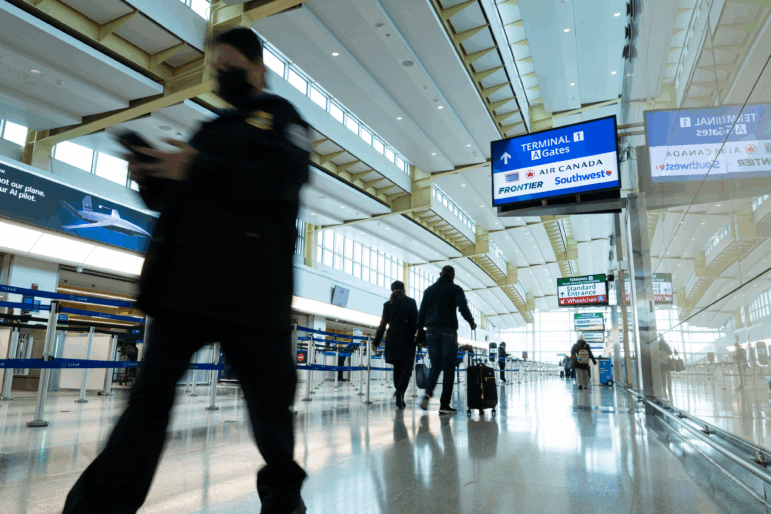 Travelers and staff walk through Ronald Reagan Washington National Airport in Arlington, Va., on Friday. U.S. Transportation Security Administration security officers missed their first full paycheck Friday as a partial funding shutdown of the government approached the one-month mark.